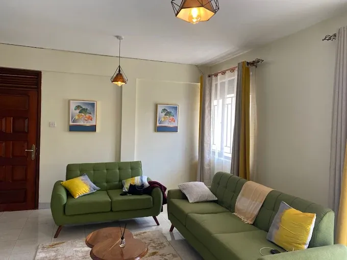Spacious lounge with green sofas